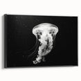 Framed canvas wall art depicting a vibrant jellyfish design in shades of blue and purple, showcasing marine life with a sleek black frame. Perfect for ocean-themed decor.