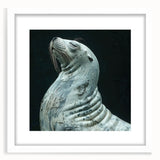 White-framed wall art featuring a vibrant marine life design of a playful sea lion, set against a textured background, perfect for ocean-themed decor.