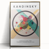 Mid-century modernist art featuring abstract shapes in vibrant colors on a gold-framed acrylic.