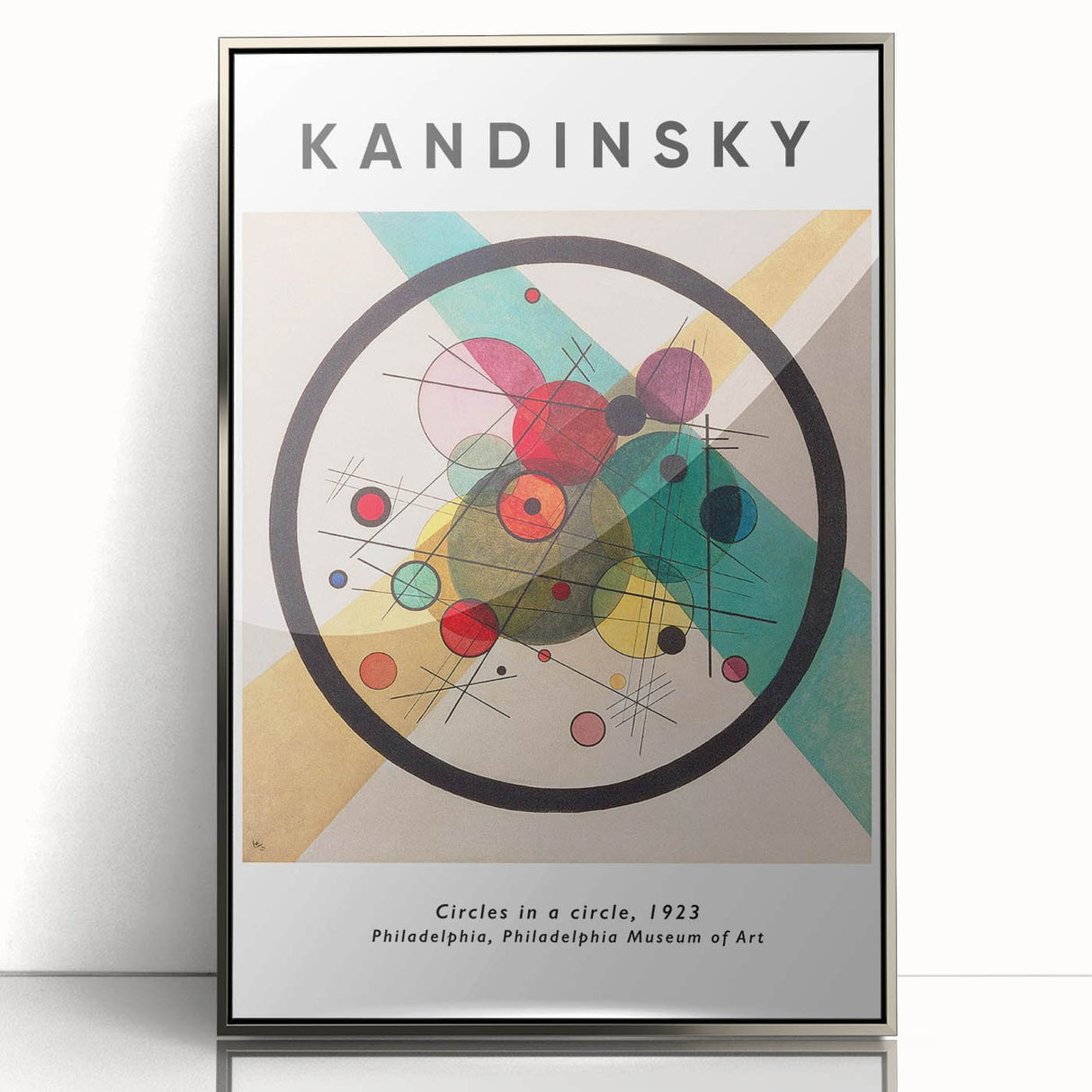 Mid-century modernist art featuring abstract geometric shapes in vibrant colors on a silver-framed acrylic print.