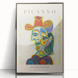 Mid-century modernist art featuring abstract shapes in bold colors on a silver-framed acrylic print.