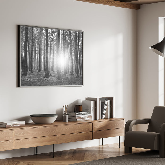 Black and white forest wall art above a modern wood sideboard in a calming natural interior