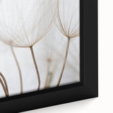 Close-up of a black framed canvas featuring a colorful, textured floral design, ideal for living room decor.