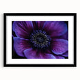 Abstract art print featuring vibrant, colorful florals on a textured canvas, framed in black, suitable for living room decor.