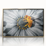 Large art print of a close-up floral design in muted earth tones on a gold-framed acrylic.