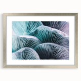 Textured art print of abstract florals in soft pink and white, framed in silver, suitable for bedroom decor.