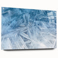 Close-up of frost patterns on acrylic glass, in cool blue and white tones, ideal for bedroom or dining room wall art.