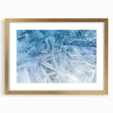 Textured art featuring abstract frost patterns in white and blue, framed in gold, ideal for bedroom art.