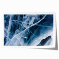 Close-up of frost patterns on ice, depicted in muted blue and white tones on a rolled canvas.