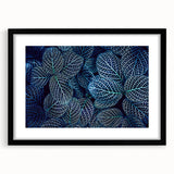Colorful abstract art print of textured leaves, in a black frame with mat, ideal for living room decor.