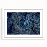 Abstract art print featuring close-up leaves design in green and yellow, framed in white.