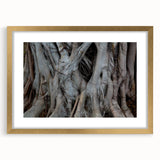 Abstract art print of textured trees in muted earth tones on a large framed canvas, ideal for living room decor.