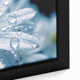 Close-up of textured black wall art featuring colorful, abstract water design on a framed canvas.