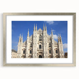 Abstract art print of a cathedral, featuring muted blue and gray tones on a framed silver mat, ideal for dining room decor.