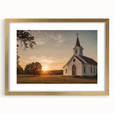 Textured abstract art print of a stylized church in muted gold and white, framed with a gold mat, suitable for bedroom decor.
