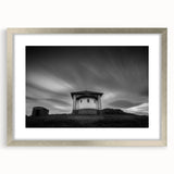 Abstract art print of a church in muted gray and blue tones, framed in silver, ideal for dining room decor.