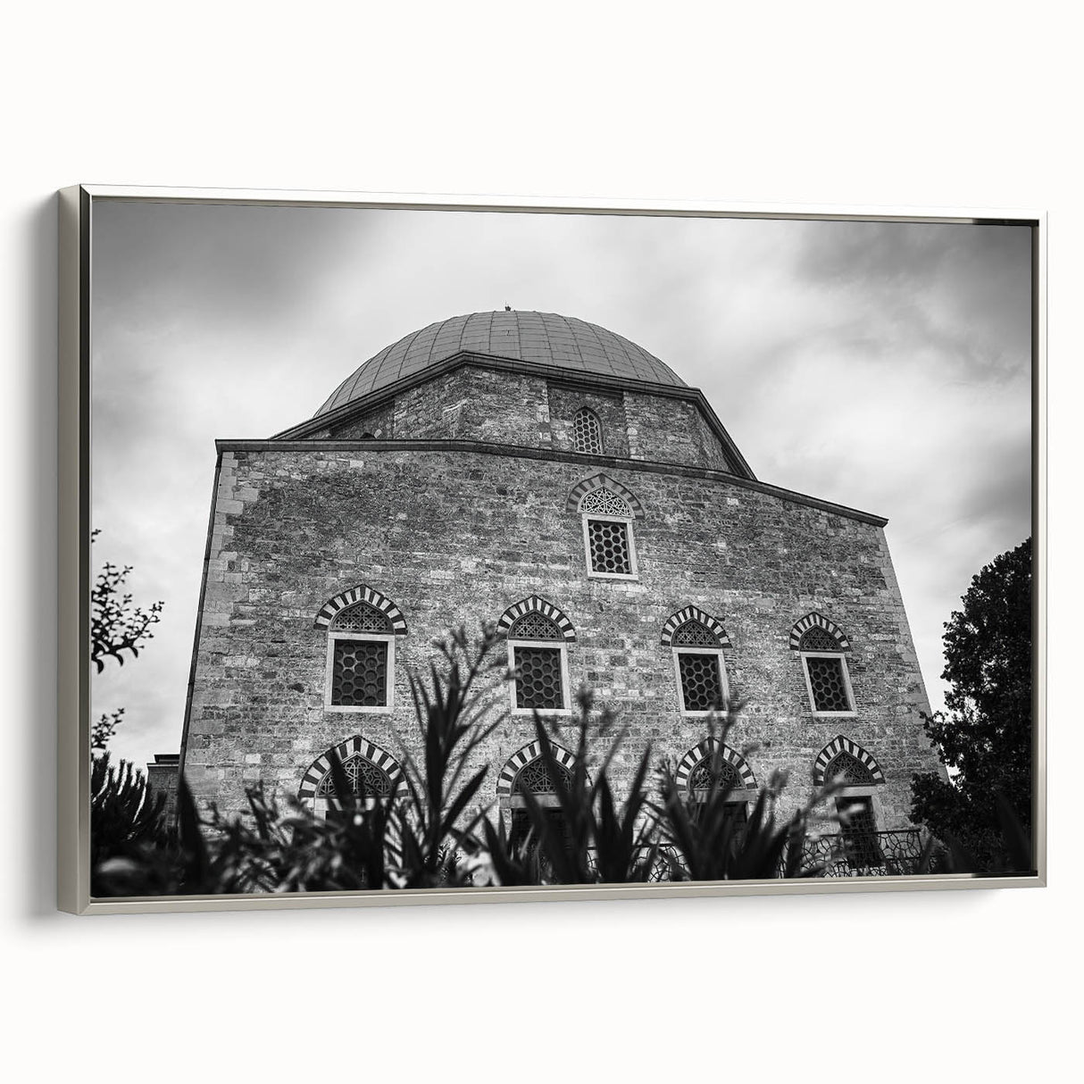 Framed canvas of a vintage poster featuring a mosque design, with a palette of black and vibrant colors.