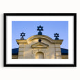 Abstract art print featuring a colorful, textured depiction of a synagogue, set in a black frame with mat.