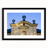 Abstract art print featuring a colorful, textured depiction of a synagogue, set in a black frame with mat.