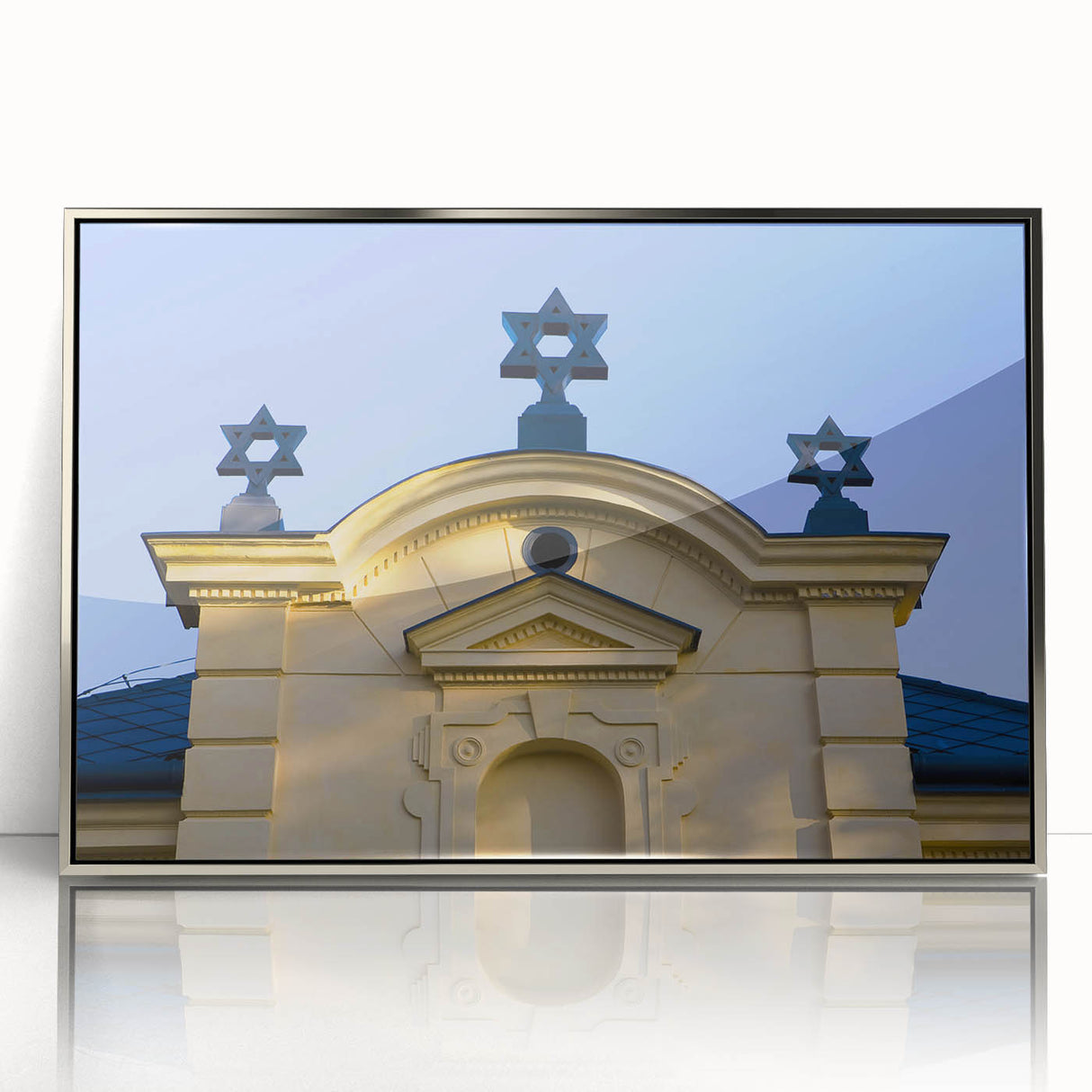Art deco poster of a synagogue in silver frame, featuring geometric patterns in muted colors.
