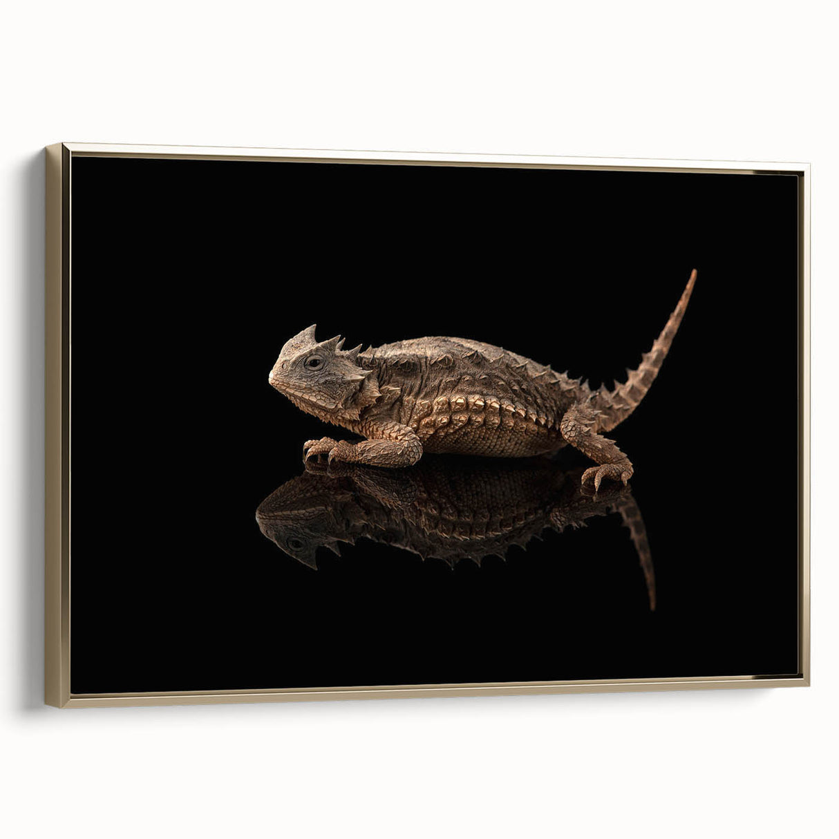 Framed wall art featuring a vibrant lizard design in gold tones, showcasing intricate details and textures, perfect for reptile enthusiasts and home decor lovers.