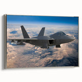 Vintage poster art of a silver airplane on a black background in a silver frame, suitable for living room decor.