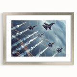 Abstract art print of airplanes in muted gray and blue tones, framed in silver.