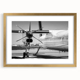 Abstract art print of an airplane in gold and black tones on a framed canvas, suitable for bedroom or dining room decor.