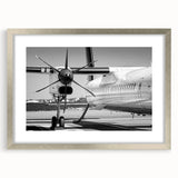 Textured art print of abstract airplanes in muted gray and silver tones on a framed canvas, suitable for bedroom decor.