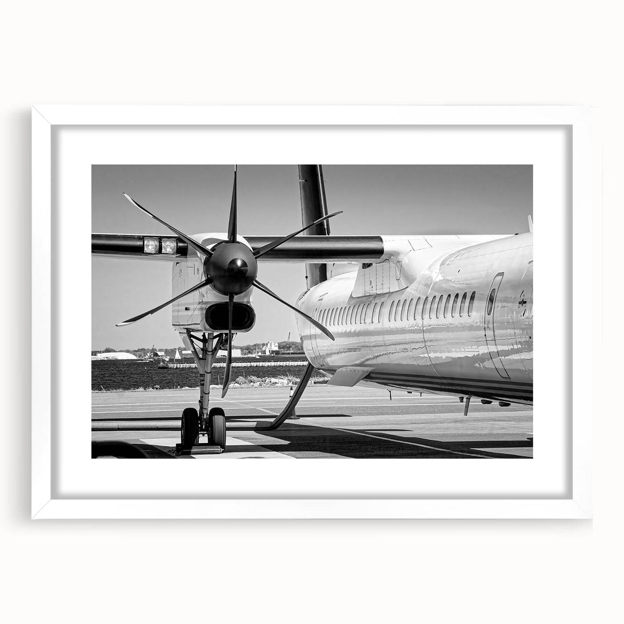 Extra large abstract art print of a textured airplane, in muted grays and blues, framed in white.