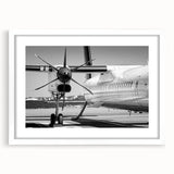 Extra large abstract art print of a textured airplane, in muted grays and blues, framed in white.