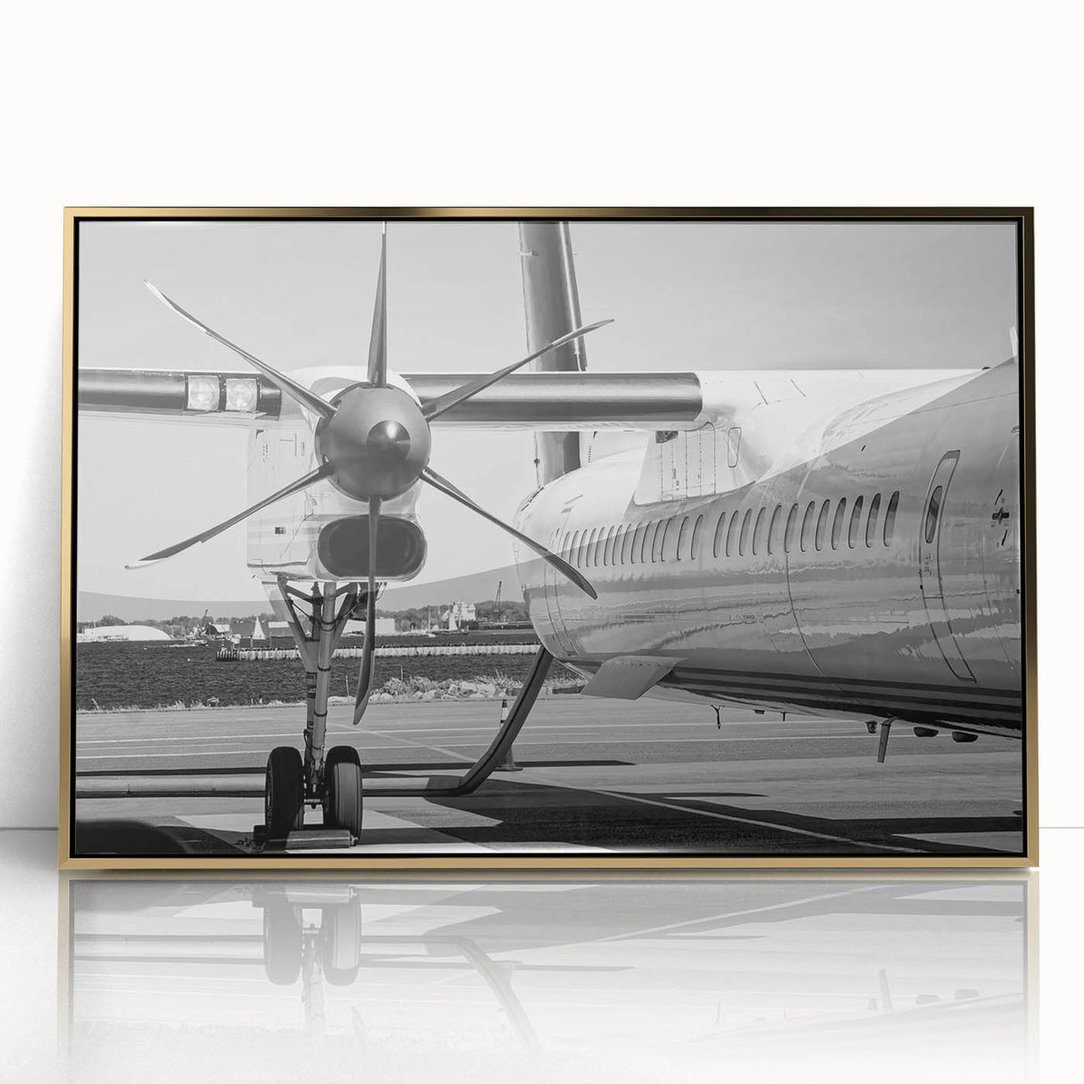 Large abstract wall art featuring a mid-century modernist airplane design in gold and black tones on a framed acrylic print.