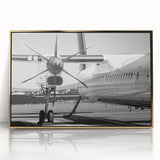 Large abstract wall art featuring a mid-century modernist airplane design in gold and black tones on a framed acrylic print.