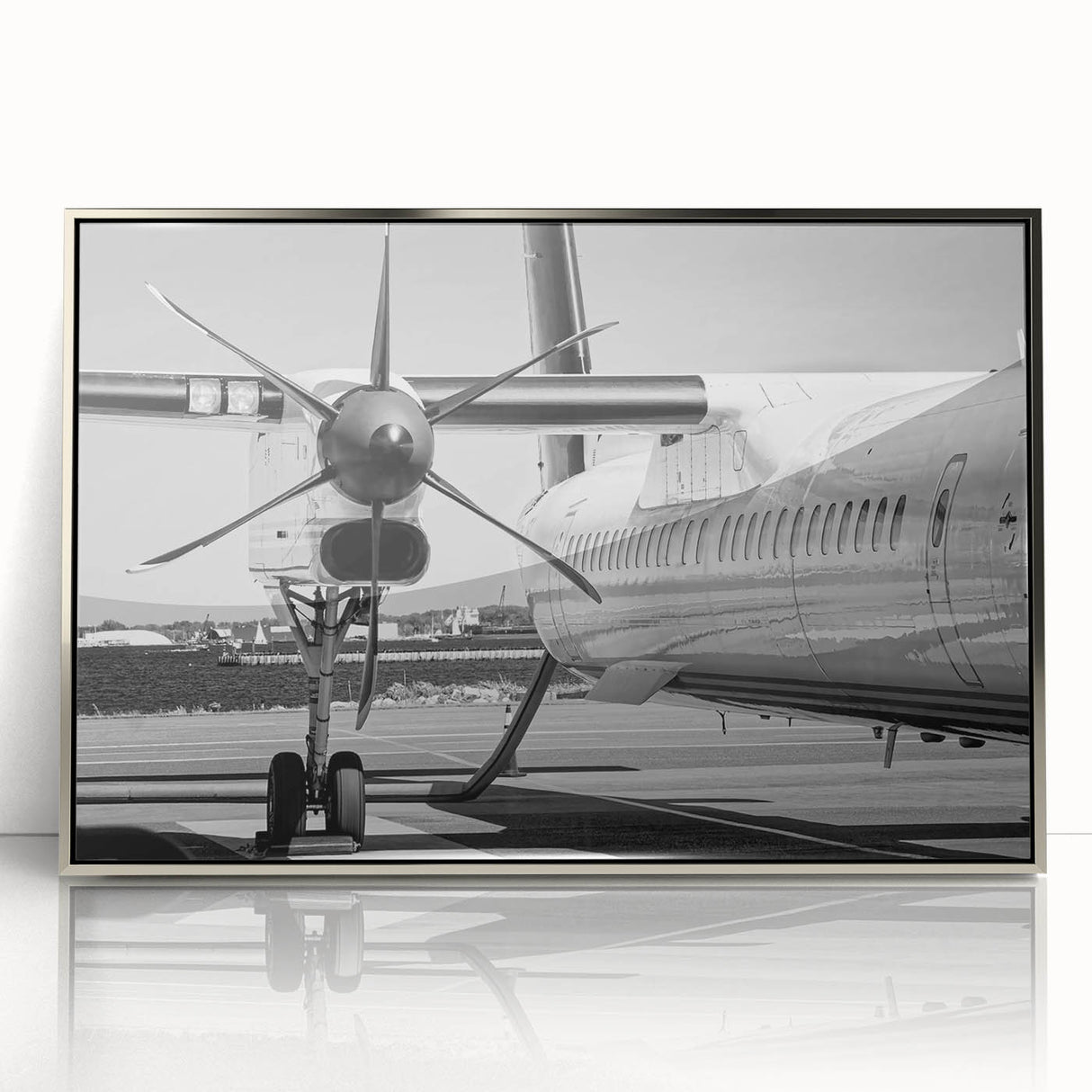 Mid-century modernist style airplane illustration in muted gray and blue tones on a silver-framed acrylic print.