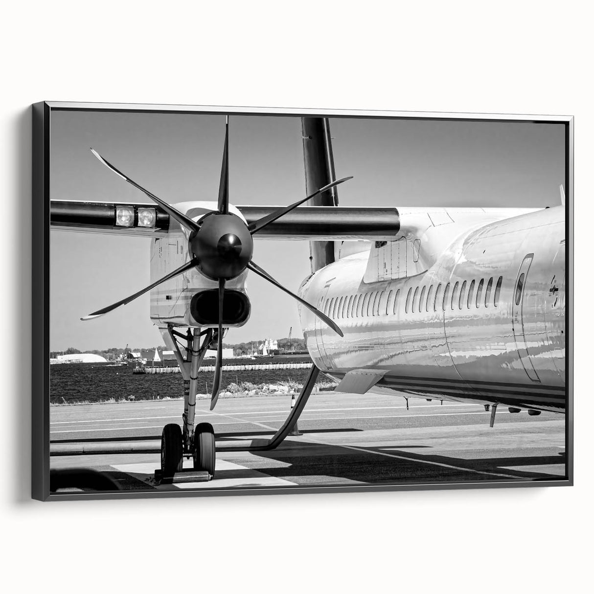 Black and white framed canvas featuring a vintage airplane side view, suitable for bedroom wall decor.