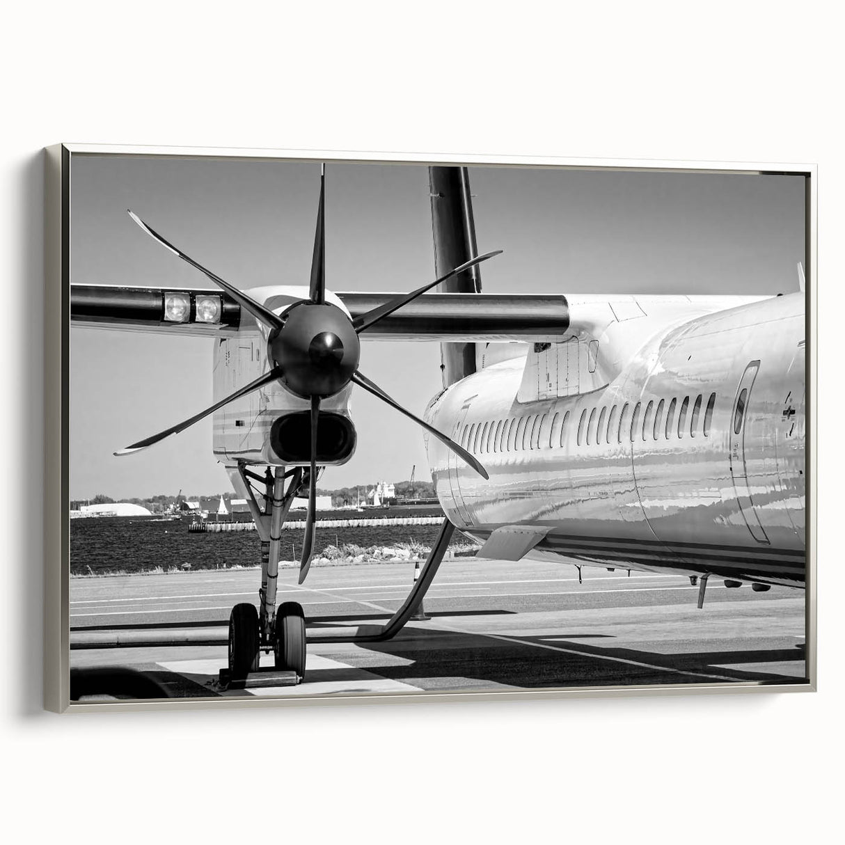 Framed canvas featuring a vintage airplane in grayscale against a colorful abstract landscape, ideal for office decor.