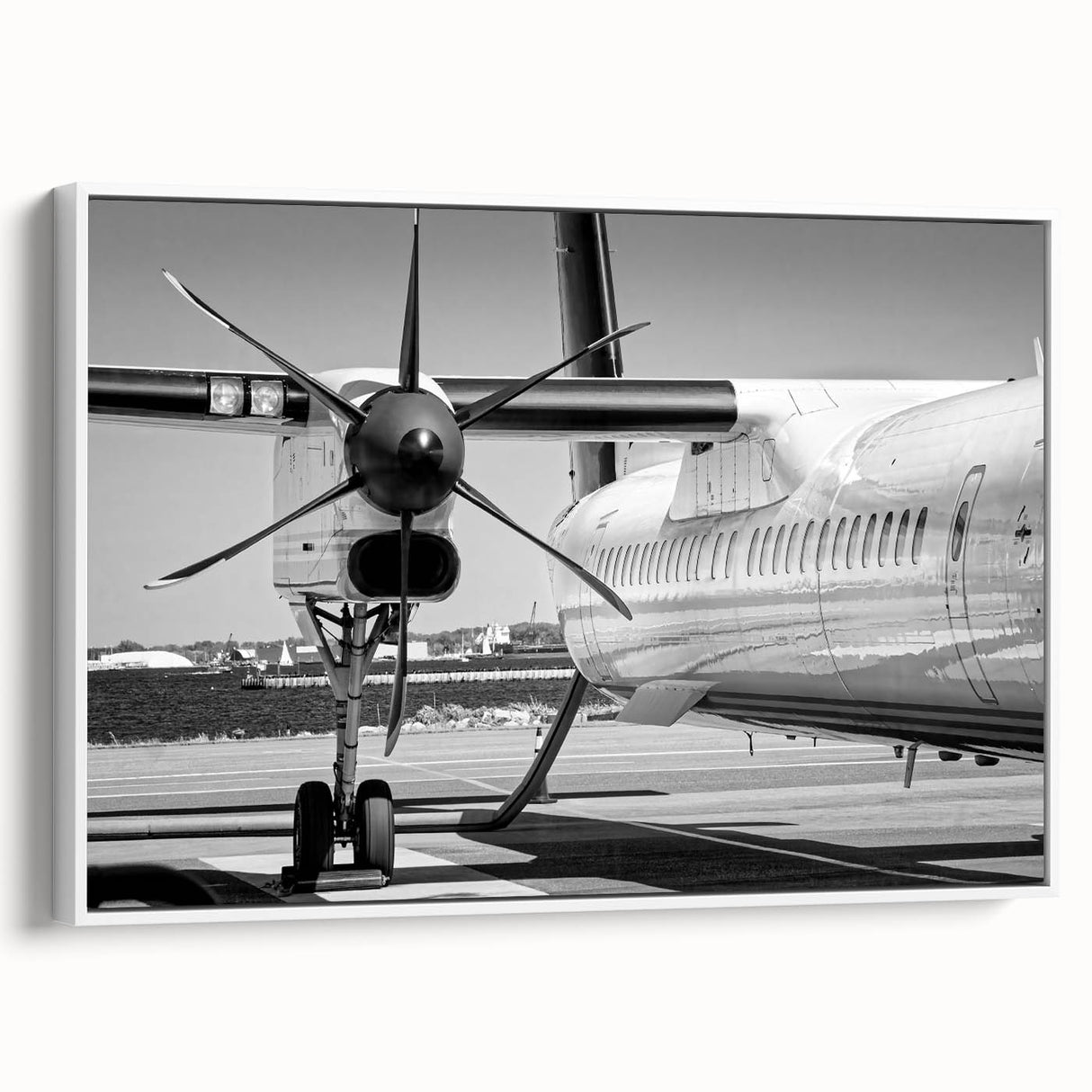 Vintage poster art of a classic airplane on a white framed canvas, featuring a monochrome palette.