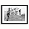 Abstract art print of a colorful, textured bicycle on a large canvas, framed in black, suitable for living room decor.