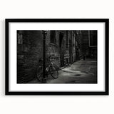 Extra large abstract art print of a colorful bicycle on textured canvas, framed in black, ideal for living room decor.