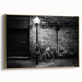Framed canvas of a vintage bicycle in black and gold tones, ideal for bedroom wall art.