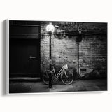 Vintage poster art of a black bicycle on a colorful background, framed canvas, ideal for living room decor.