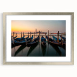 Abstract art print of a stylized gondola on water in muted blue and gray tones, framed with a silver mat.