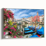 Vintage poster art of a gondola on a canal, featuring a silver frame and a palette of black and vibrant colors.