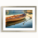Abstract art print of a rowboat in muted gray and blue tones, framed in silver, ideal for dining room decor.