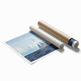 Rolled print of a sailboat on calm waters in muted blue and gray tones, suitable for classy bathroom wall art.