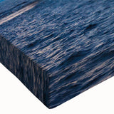 Large art depicting a black and white landscape painting of a ship at sea on stretched canvas.