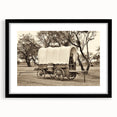 Abstract art print of colorful, textured vehicles on a large canvas, framed in black, ideal for living room decor.