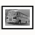 Abstract art print featuring a colorful, textured depiction of service vehicles, in a large black frame.