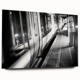 Side view of a large abstract train print on acrylic glass, featuring muted metallic tones.