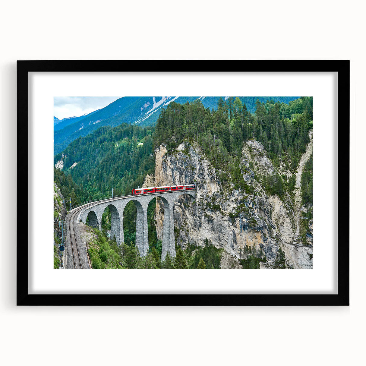 Abstract colorful art print of a train, with vibrant hues on a textured canvas, framed in black.